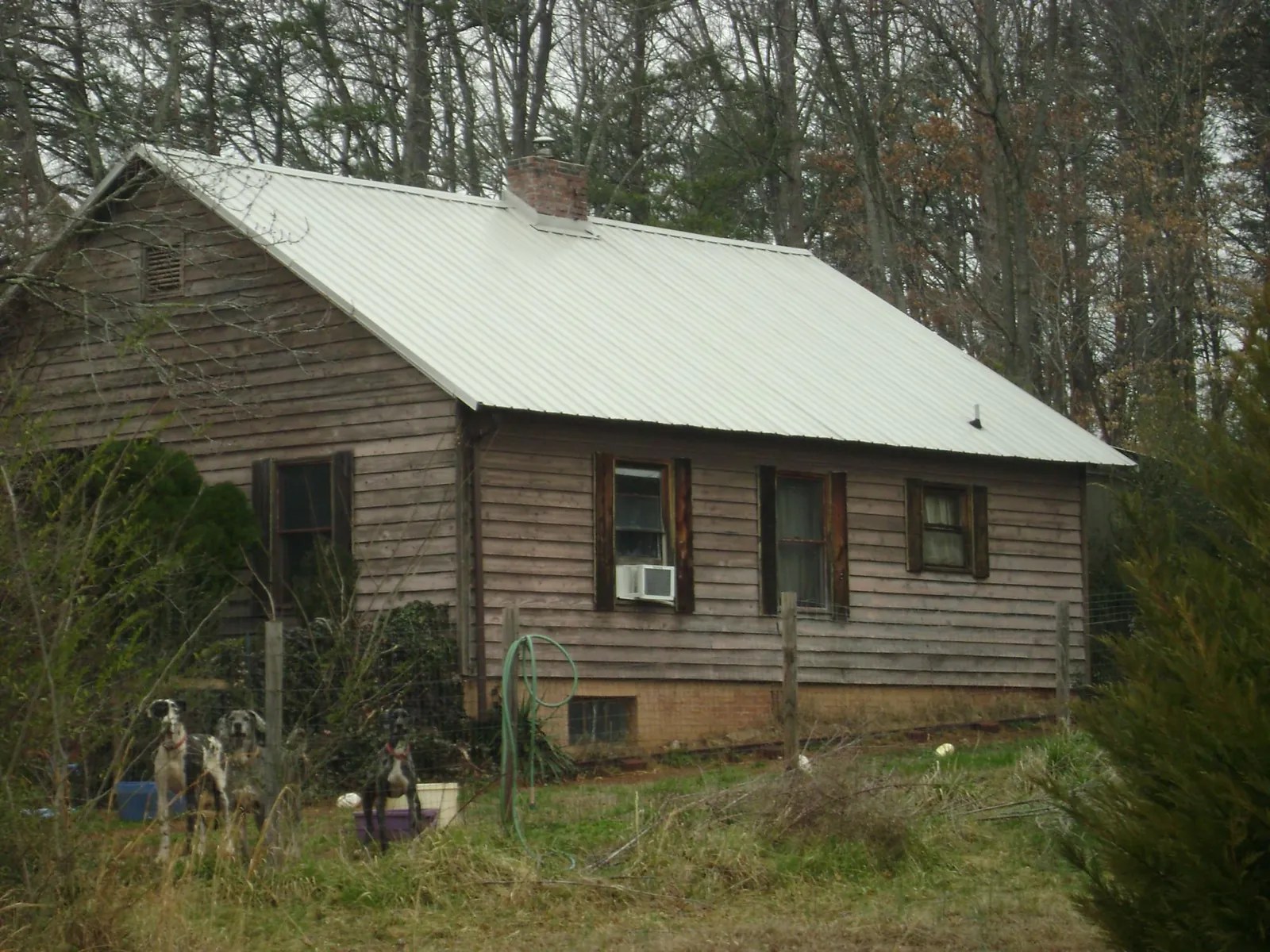 White metal roof on an old wood sided farmhouse, from a Metal Roof Installation job in Roaring Spring